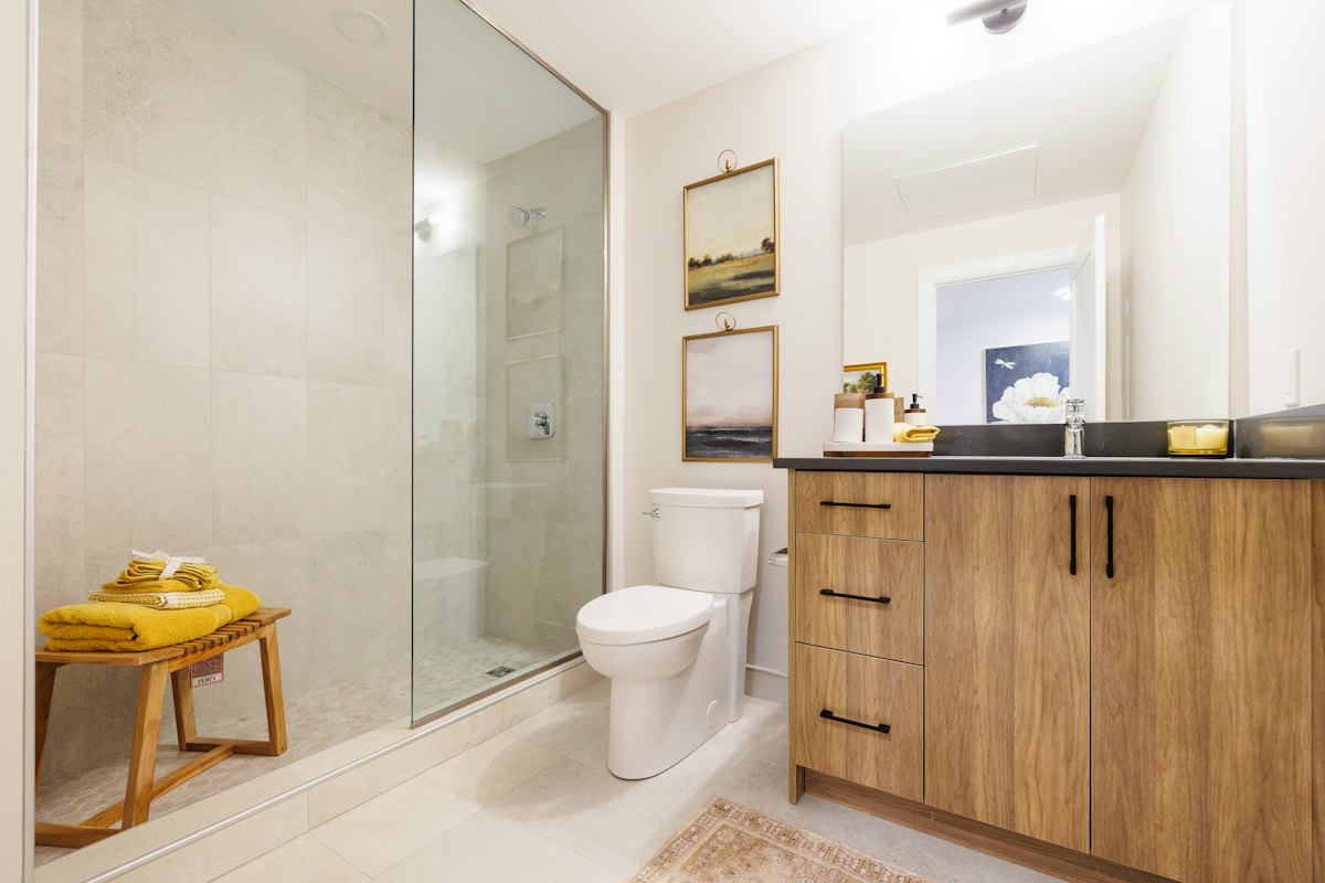 Bathroom with wood vanity and glass shower