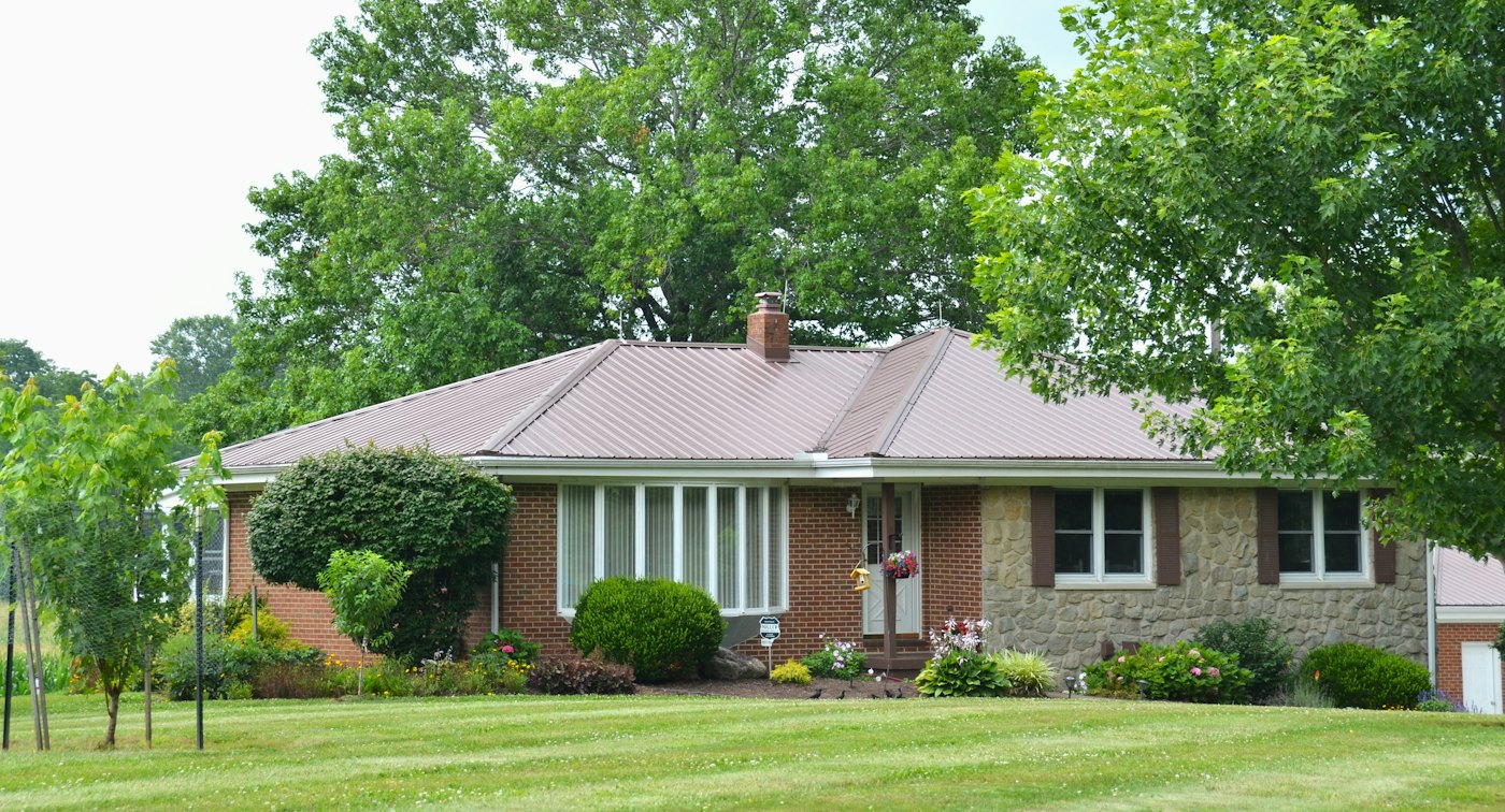 Brick and stone ranch with mature trees
