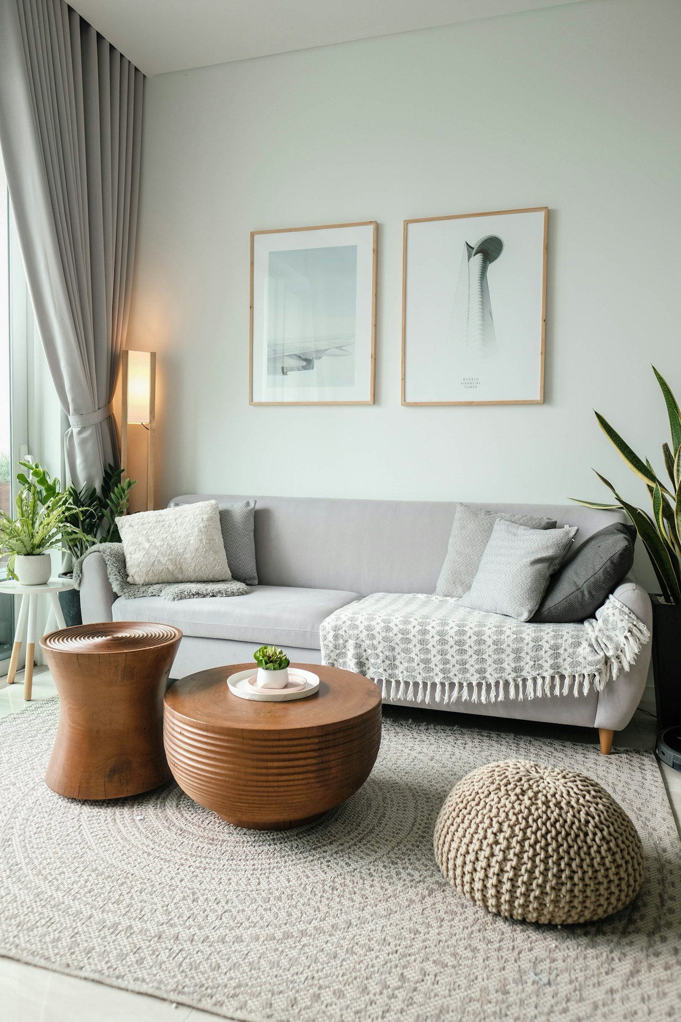 Calm living room with a light gray sofa and plants