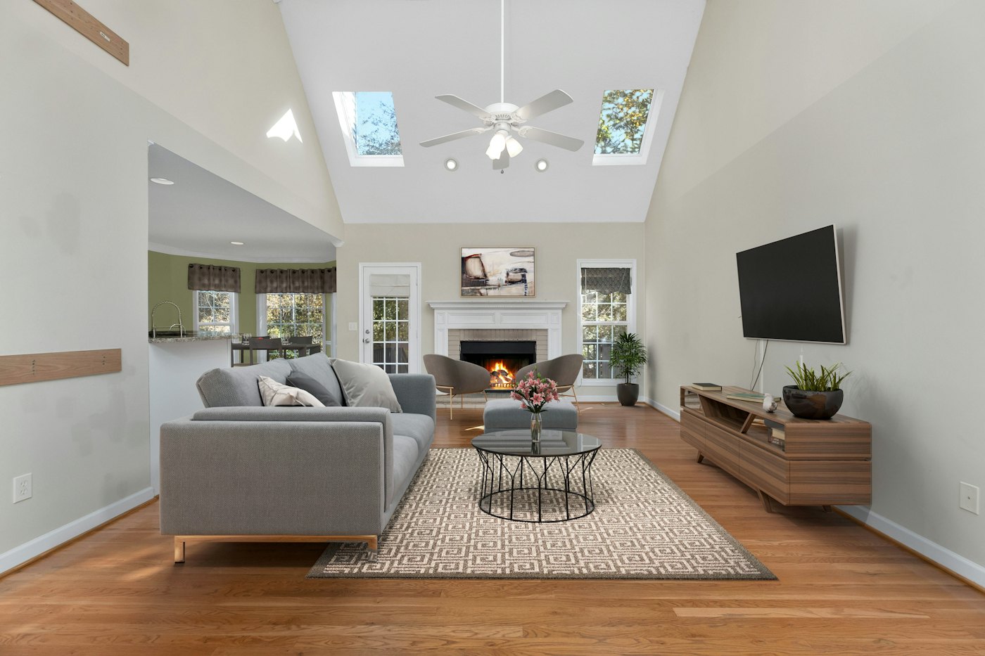 Bright living room with a vaulted ceiling and fireplace, ready for guests